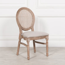 Load image into Gallery viewer, A classic Louis-style dining chair carved from birch wood with a light washed finish, featuring a woven balloon back, linen upholstered seat, and stackable design for practical elegance.