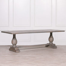 Load image into Gallery viewer, A handcrafted 260cm rectangular dining table made from solid mango wood, featuring a rustic finish with a subtle grey wash and elegant hand-carved columned pedestal bases.