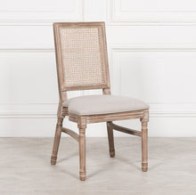 Load image into Gallery viewer, Elegant and timeless, this Wooden Louis Dining Chair features a carved birch frame with a subtle wood wash, a rattan square back, and a linen-upholstered seat, and is conveniently stackable.