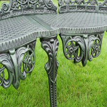 Load image into Gallery viewer, Decorative metal bench with intricate designs on a grassy background