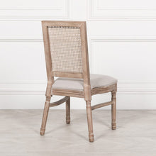 Load image into Gallery viewer, Elegant and timeless, this Wooden Louis Dining Chair features a carved birch frame with a subtle wood wash, a rattan square back, and a linen-upholstered seat, and is conveniently stackable.
