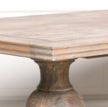 Load image into Gallery viewer, A beautifully handcrafted 240cm dining table made from solid mango wood, featuring a light rustic finish and two detailed hand-carved columned pedestal legs.