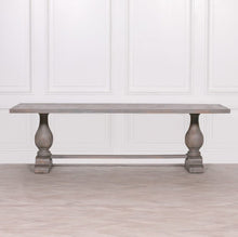 Load image into Gallery viewer, A handcrafted 260cm rectangular dining table made from solid mango wood, featuring a rustic finish with a subtle grey wash and elegant hand-carved columned pedestal bases.