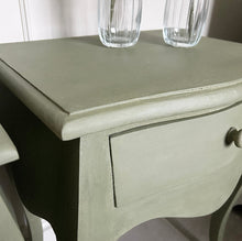 Load image into Gallery viewer, Light gray wooden side table with two clear glass vases on top.