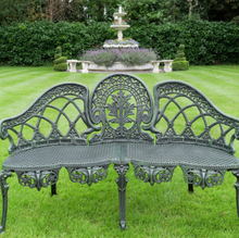 Load image into Gallery viewer, Decorative garden bench on a grassy lawn with a fountain in the background