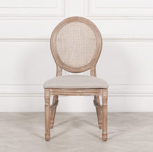 Load image into Gallery viewer, A classic Louis-style dining chair carved from birch wood with a light washed finish, featuring a woven balloon back, linen upholstered seat, and stackable design for practical elegance.