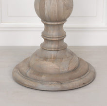 Load image into Gallery viewer, A beautifully handcrafted 147cm round dining table in a rustic finish, featuring a solid wood top and an elegant hand-carved columned pedestal base.