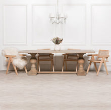 Load image into Gallery viewer, A beautifully handcrafted 240cm dining table made from solid mango wood, featuring a light rustic finish and two detailed hand-carved columned pedestal legs.