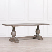 Load image into Gallery viewer, A handcrafted 210cm rectangular dining table made from solid mango wood, featuring a rustic finish with a subtle grey wash and elegant hand-carved columned pedestal bases.