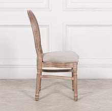 Load image into Gallery viewer, A classic Louis-style dining chair carved from birch wood with a light washed finish, featuring a woven balloon back, linen upholstered seat, and stackable design for practical elegance.