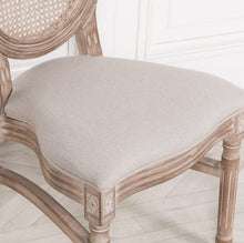 Load image into Gallery viewer, A classic Louis-style dining chair carved from birch wood with a light washed finish, featuring a woven balloon back, linen upholstered seat, and stackable design for practical elegance.