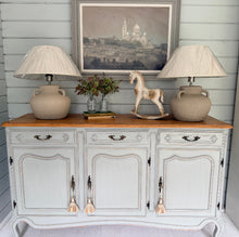 Load image into Gallery viewer, Vintage French Louis style sideboard painted in F&amp;B Lamp Room Grey with 2 stone lamps and decor on top against a light blue wall.